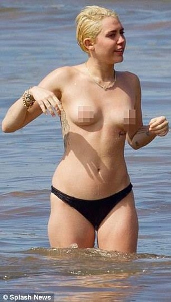 Miley Cyrus topless in the ocean with boyfriend Patrick Schwarzenegger 